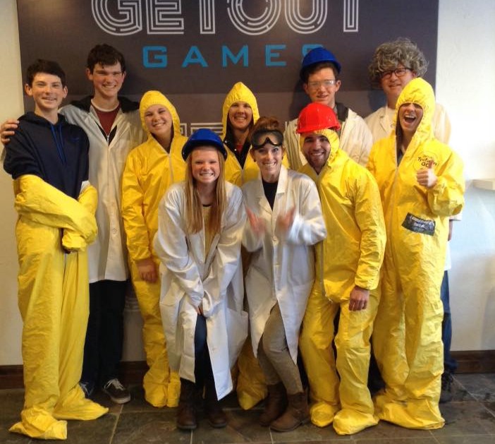 a group of friends pose in costumer after completing an escape room at Getout Games
